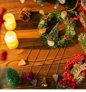 Close-up of Christmas wreath ornament with crystals, gold bells, and festive berries