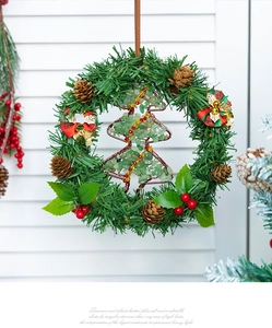 Detail of Christmas wreath with stone-filled tree, pinecones, and red plaid bow
