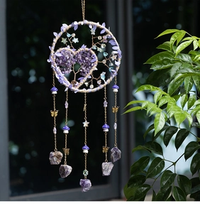 Detail of tree of life dreamcatcher with purple crystals and heart pattern decor