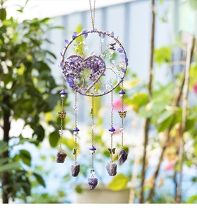 Detail of Tree of Life suncatcher with purple crystals and butterfly charms hanging outside
