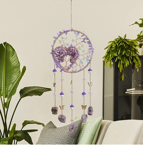 Detail of tree of life dreamcatcher with purple crystal stones and golden butterflies