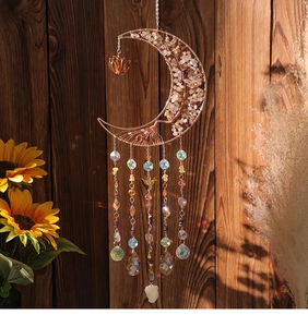 Detail of moon suncatcher with tree of life design and colorful crystal pendants