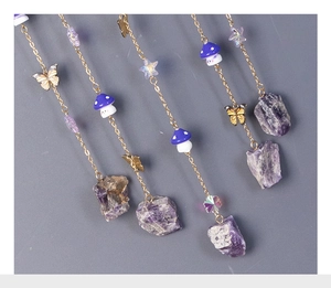 Detail of tree of life dreamcatcher with amethyst stones and golden butterfly pendants