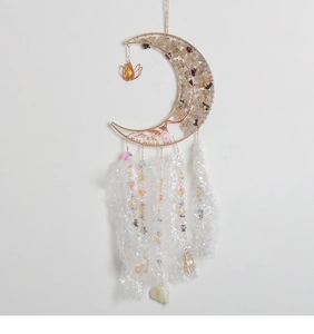 Macro detail of golden crescent moon frame with tree of life crystals and iridescent beads