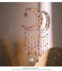 Detailed suncatcher with moon frame, chakra stones and crystals casting rainbow reflections