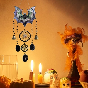 Halloween black acrylic bat wind chime with bells and black stone drops on pumpkin background
