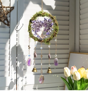 Detail of Tree of Life dream catcher with purple crystals and agate slices on white shutters