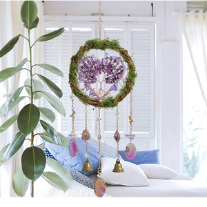 Detail of life of tree wall hanging with purple crystal heart and agate stone slices