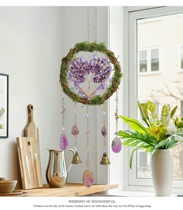 Detail of tree of life hanging ornament with purple crystal heart and agate slices