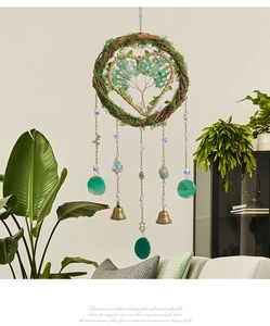 Detail of handmade Tree of Life dreamcatcher featuring green agate slices and moss