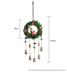 Detailed view of 14cm green Christmas wreath with hanging metal chains and glass vials
