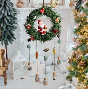 Vertical Christmas wall decor with Santa figurine, bells, and mini glass bottles