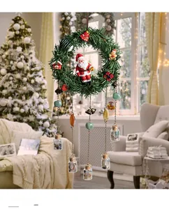Christmas wreath wind chime with Santa figurine and gemstone glass bottles in cozy room