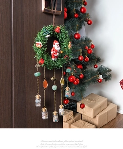 Detailed view of a forest-style Christmas wreath with Santa and natural stones