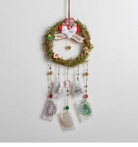 Detail of Christmas rattan wreath with Santa decor and hanging bells with crystal pendants