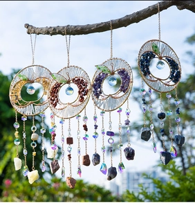 Close-up of apple-shaped suncatcher with natural stones and multifaceted crystal balls