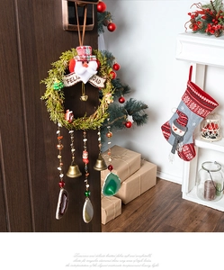 Detail of Christmas wreath with Santa, vintage bells and natural agate stone hanging