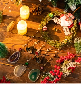 Close-up of Feliz Navidad Christmas wreath with agate slices and golden bells
