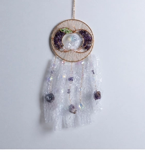 Macro detail of Tree of Life suncatcher with amethyst stones and apple-shaped wire wrap