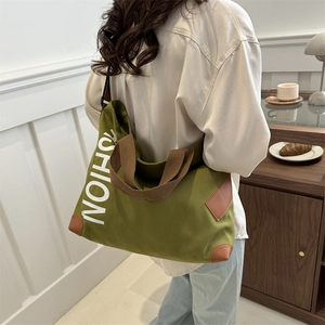 Green canvas tote bag with brown straps and large white SHION lettering for daily use