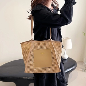 Large woven straw tote bag with leather straps and patch for summer beach or commute