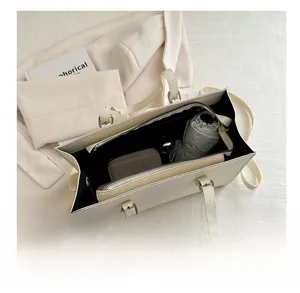 Internal view of the cream tote bag showing large capacity for umbrella and wallet