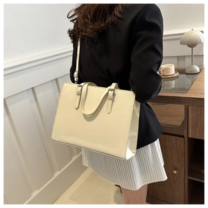 Minimalist beige rectangular tote bag worn by a model in a professional indoor office setting
