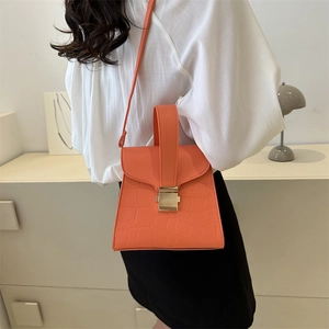 Orange faux crocodile leather handbag with metal lock and crossbody strap