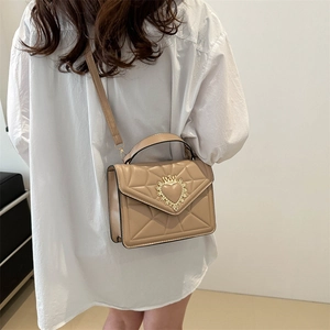 Quilted beige chain shoulder bag with elegant gold heart crown buckle for women