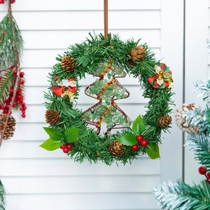 Christmas wreath ornament with pine needles, red berries and stone-filled wire tree