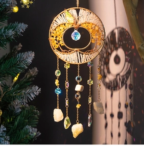 Detail of apple-shaped tree of life suncatcher with yellow crystals and golden chain