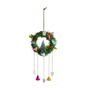 Vintage Christmas wreath with metal bells, pine needles, colorful stones, and red berries