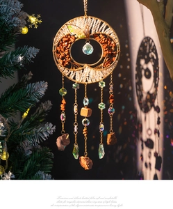 Detail of life tree suncatcher with natural stones, crystal ball and golden chains