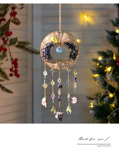 Detail view of golden tree of life suncatcher with crystals and blue stones decoration