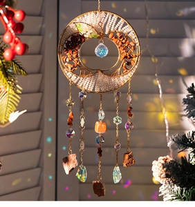 Detailed view of apple-shaped tree of life suncatcher with rainbow crystal prisms and stones