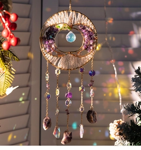 Detail of tree of life suncatcher with purple amethyst stones and crystal ball hanging