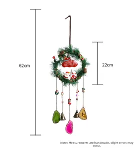 Detail of Christmas wreath wind chime with Merry Christmas sign and colorful agate stones
