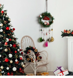 Detail of Christmas wreath wall decor with bells and colorful agate slices for home