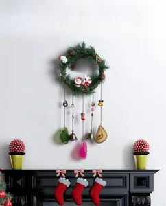 Detailed view of Christmas wreath with bells, pine cones and colorful agate slices