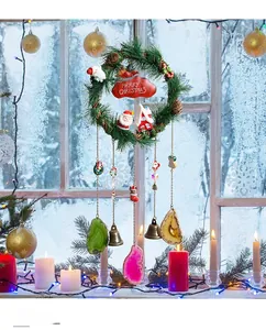 Macro detail of Christmas wreath with red sign, mini dolls, and colorful agate slices