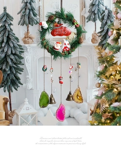 Macro shot of Christmas wreath wall hanging with agate slices and vintage metal bells