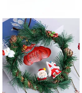 Detailed close-up of a Christmas wreath with Santa, snowman and pine cones décor