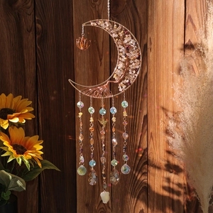 Tree of Life moon suncatcher with crystals and golden bird charms on wooden background