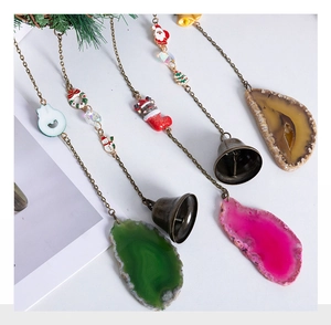 Detail of Christmas agate slice wall hangers with retro bells and holiday pendants