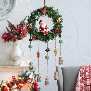 Christmas wreath wall hanging with Santa Claus, forest greenery and stone glass bottles