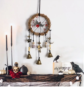 Detail of Halloween wreath with spider web, black roses and vintage metal bells