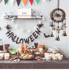 Detailed Halloween party set with BOO light box, skull lights, and spider wall decor