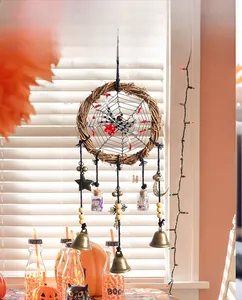 Macro view of Halloween dreamcatcher with wooden ring, spider web and mystic charms