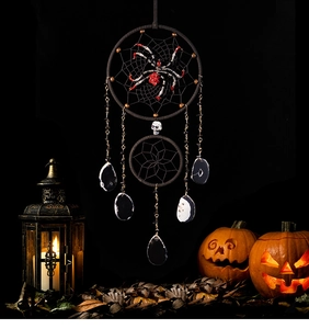 Macro detail of Halloween dream catcher with spider, skull and agate slices on black background