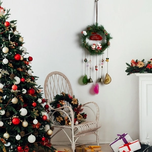 Christmas wreath wall hanging with agate slices, pine cones and festive Santa decor